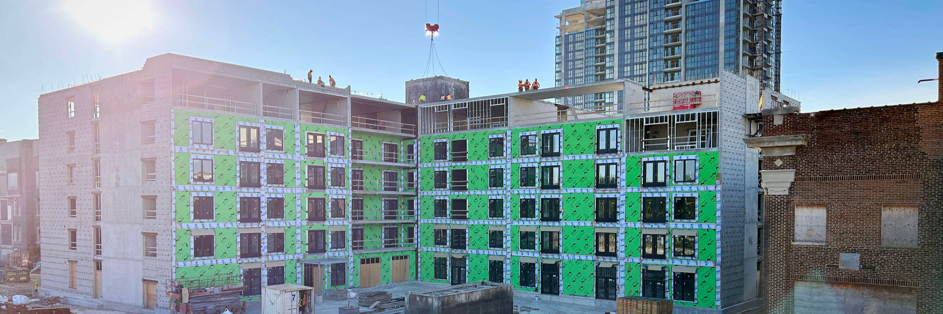 Construction site at 370 South Street in London Ontario SoHo around October 2024 with all six levels of the SoHo Zerin Place complete. Construction workers on top of the roof. Zerin is in the process of developing a 119 unit apartment building on South Street in London, Ontario.